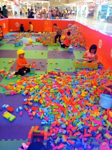 Kids playing with legos in the middle of the mall