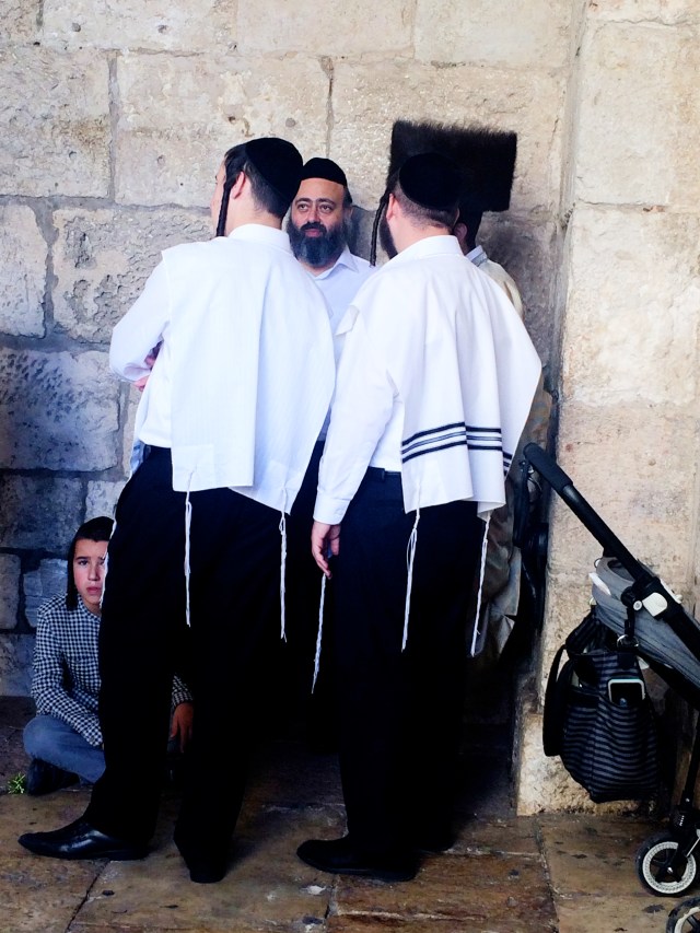 Hasidic Jewish men wearing a tzitzit and sidecurls
