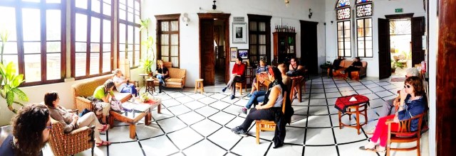 Suraida talking to guest about the history of the house/hostel.