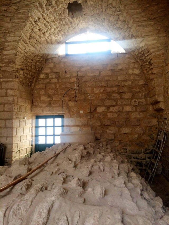 Well covered with stone in a floor level room of a house from centuries ago.